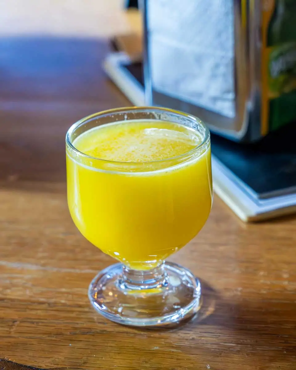 Glass full of orange poncha in Madeira, Portugal