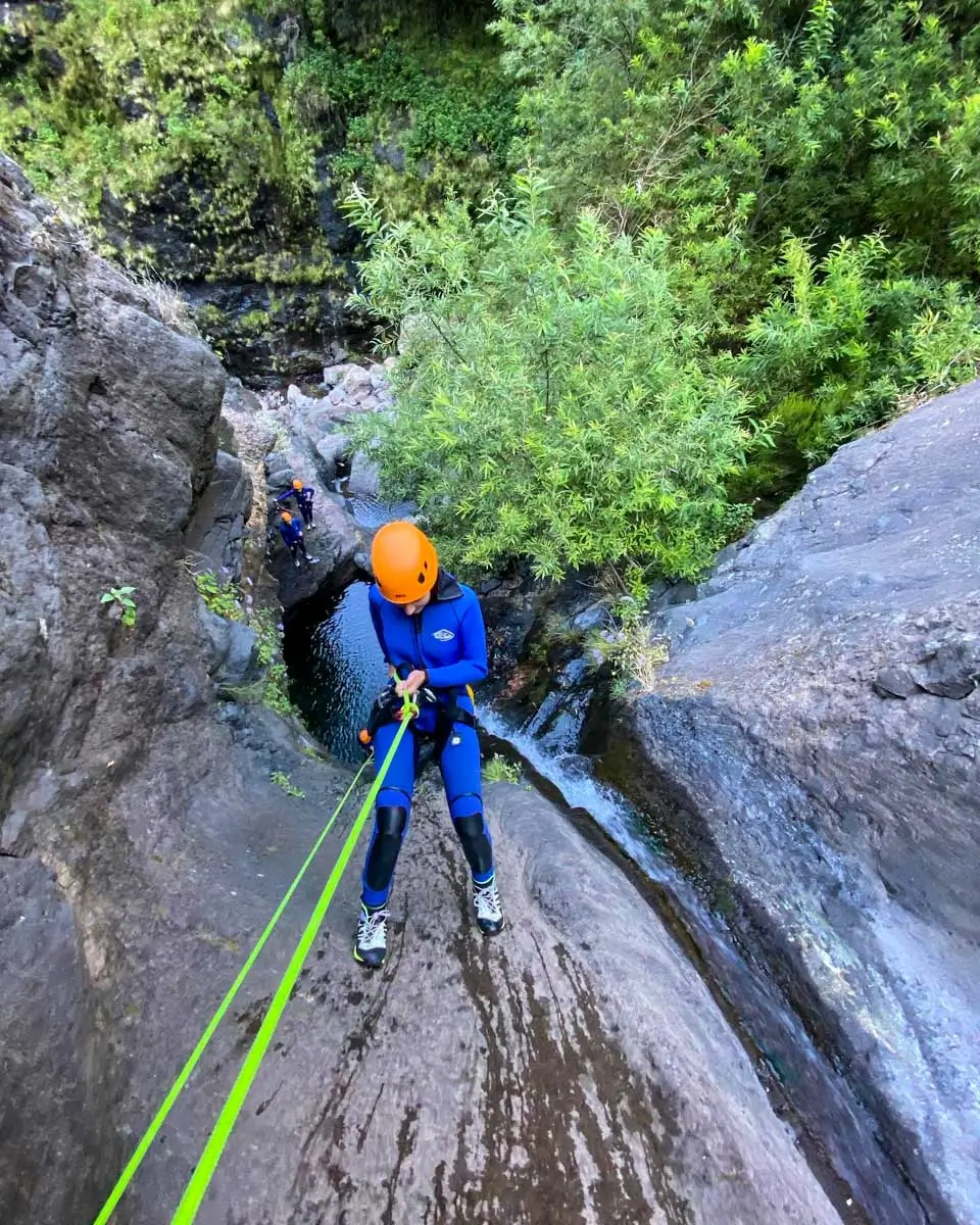 Going down the rock formation on a level 2 canyoning tour in Madeira, Portugal