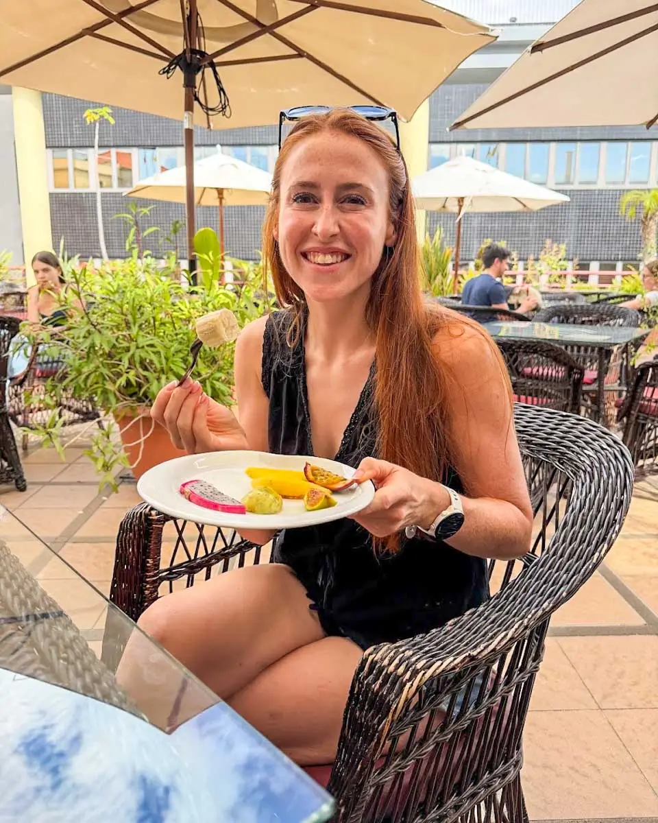 Hannah eating fruits on a food tour in Madeira, Portugal