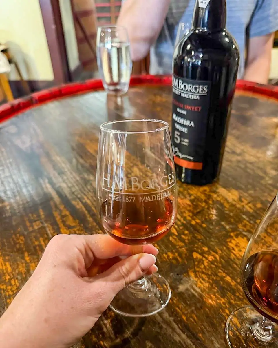 Hannah enjoys wine on a food tour in Madeira, Portugal