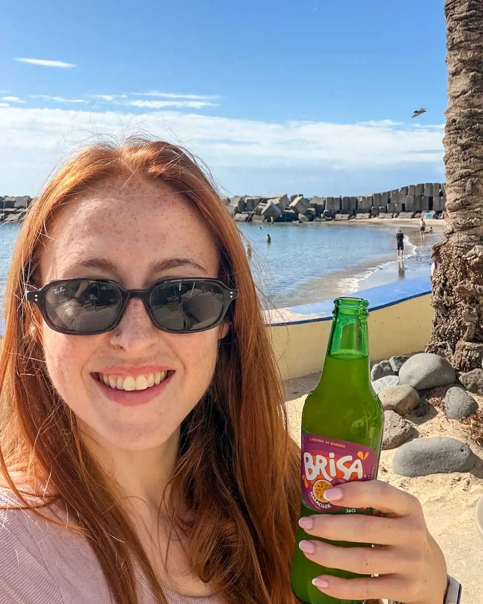 Hannah having a cold brisa at Calheta, Madeira Portugal