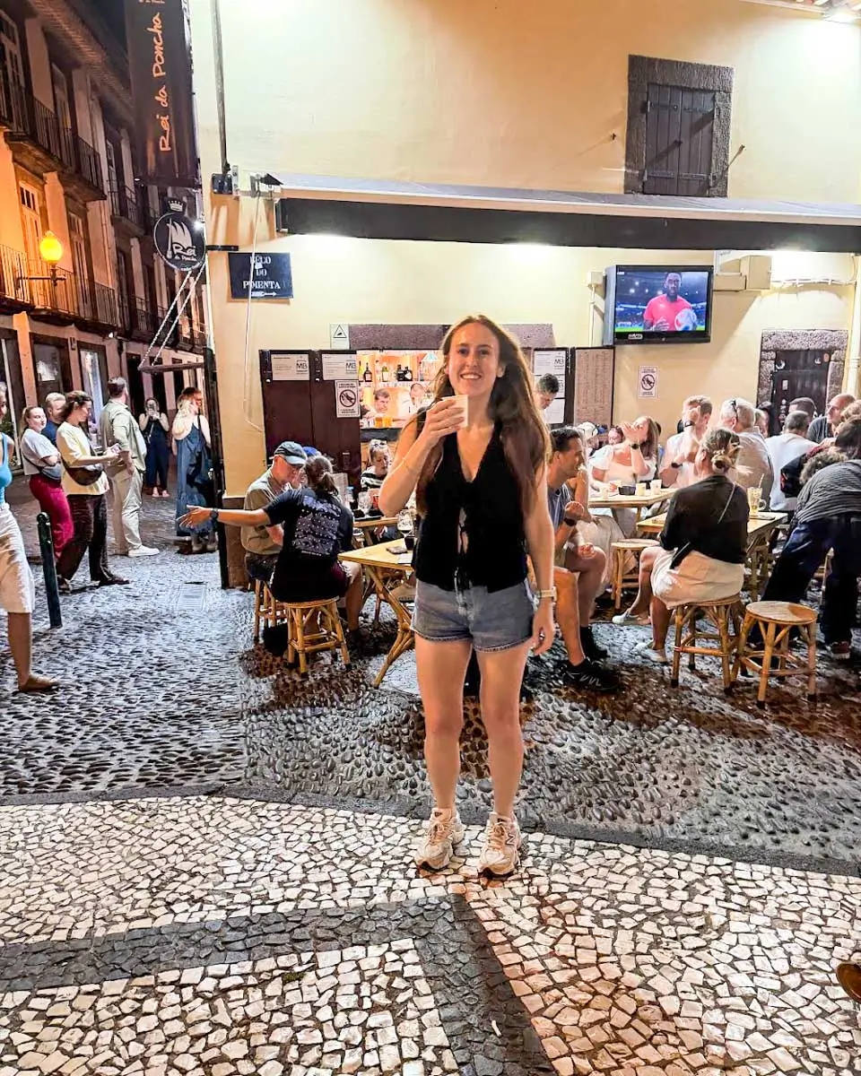 Hannah having poncha drink at Rei da Poncha, Madeira, Portugal