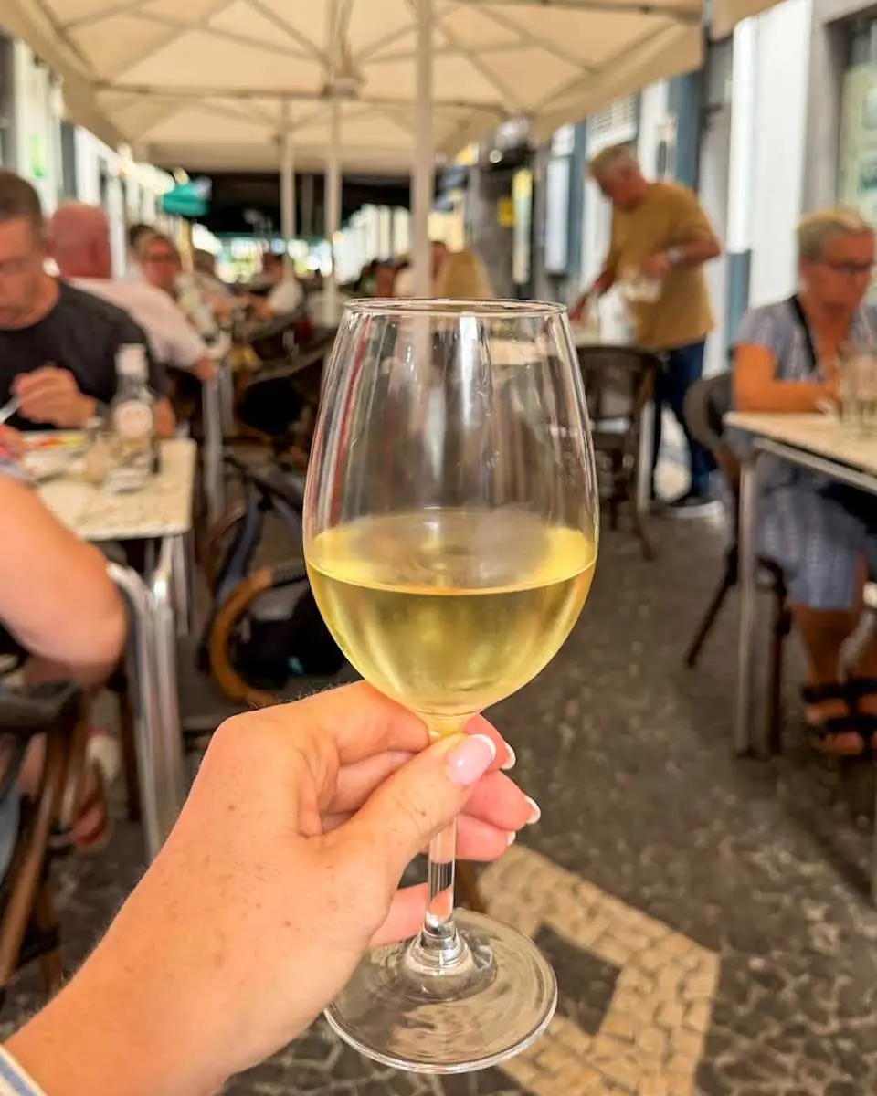 Hannah having wine at O Visconde, Madeira, Portugal