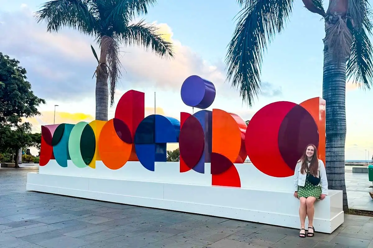 Hannah posing with Madeira sign, Madeira Portugal