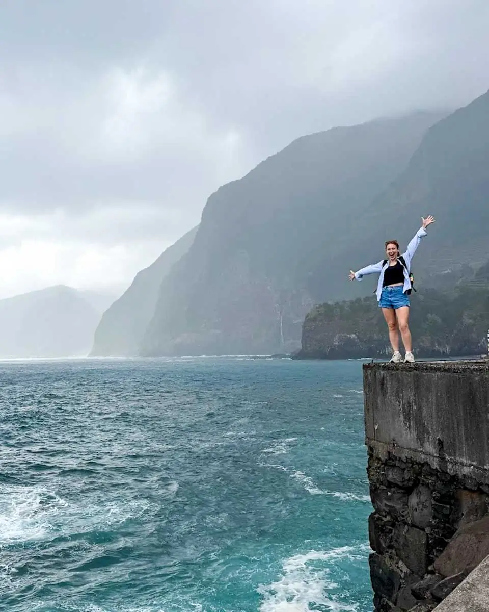 Hannah standing on the edge in Porto Monix on a jeep tour in Madeira, Portugal
