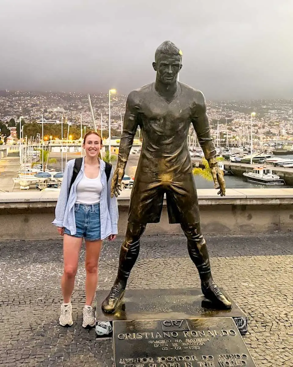 Hannah taking a photo with the statue of Ronaldo outside the Ronaldo Museum, Madeira Portugal
