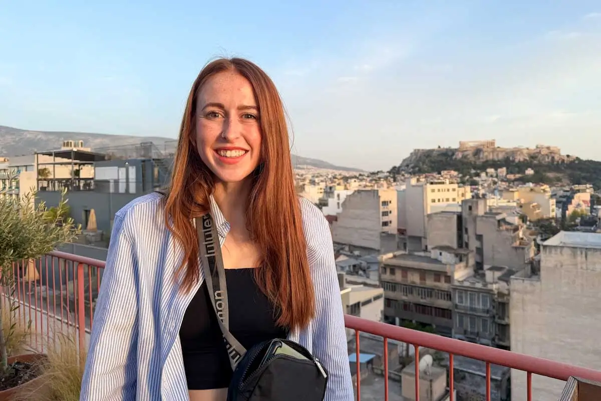 Hannah taking photo with the Acropolis in the back in Athens Greece
