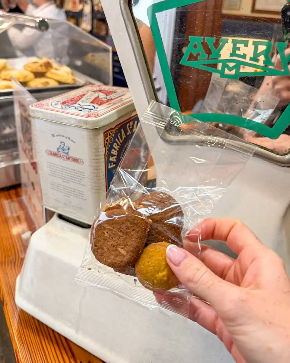 Hannah trying local biscuits on a food tour in Madeira, Portugal