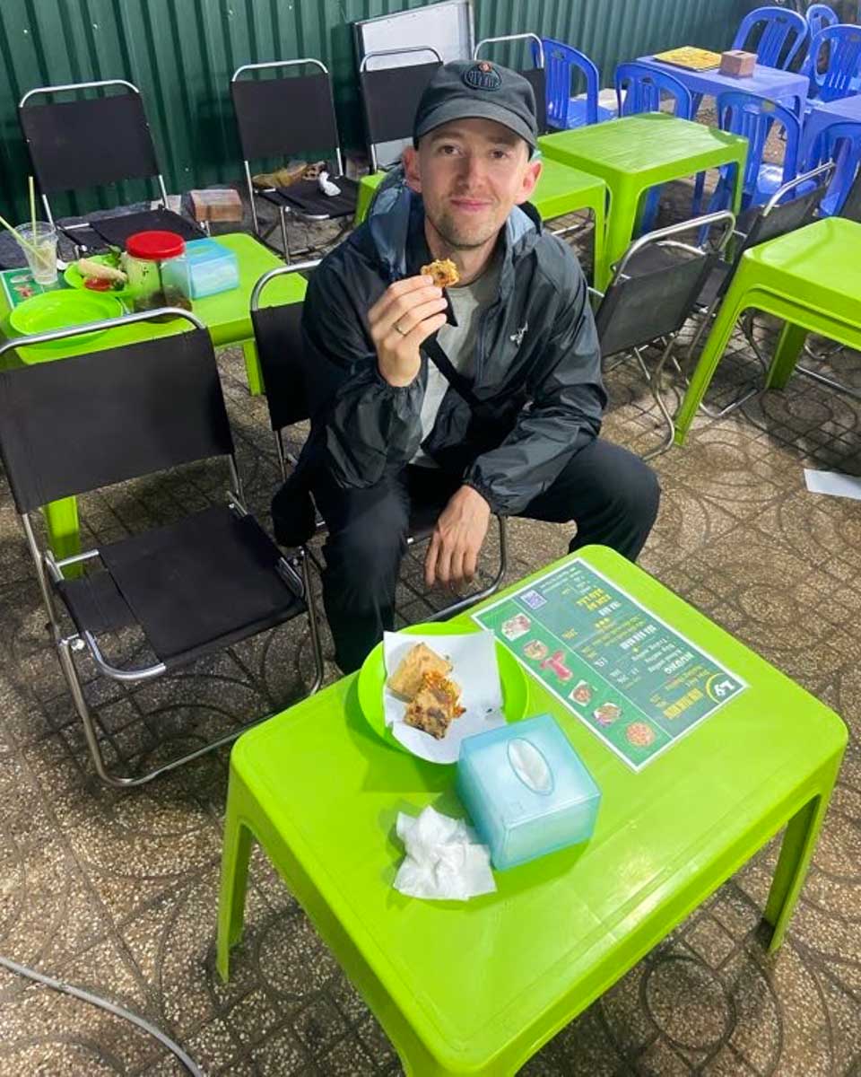 Jesse eats food on a tour in Da Nang, Vietnam