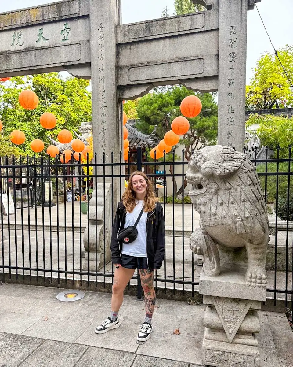 Meghan posing for a photo in Chinatown on e-bike tour in Portland, Oregon