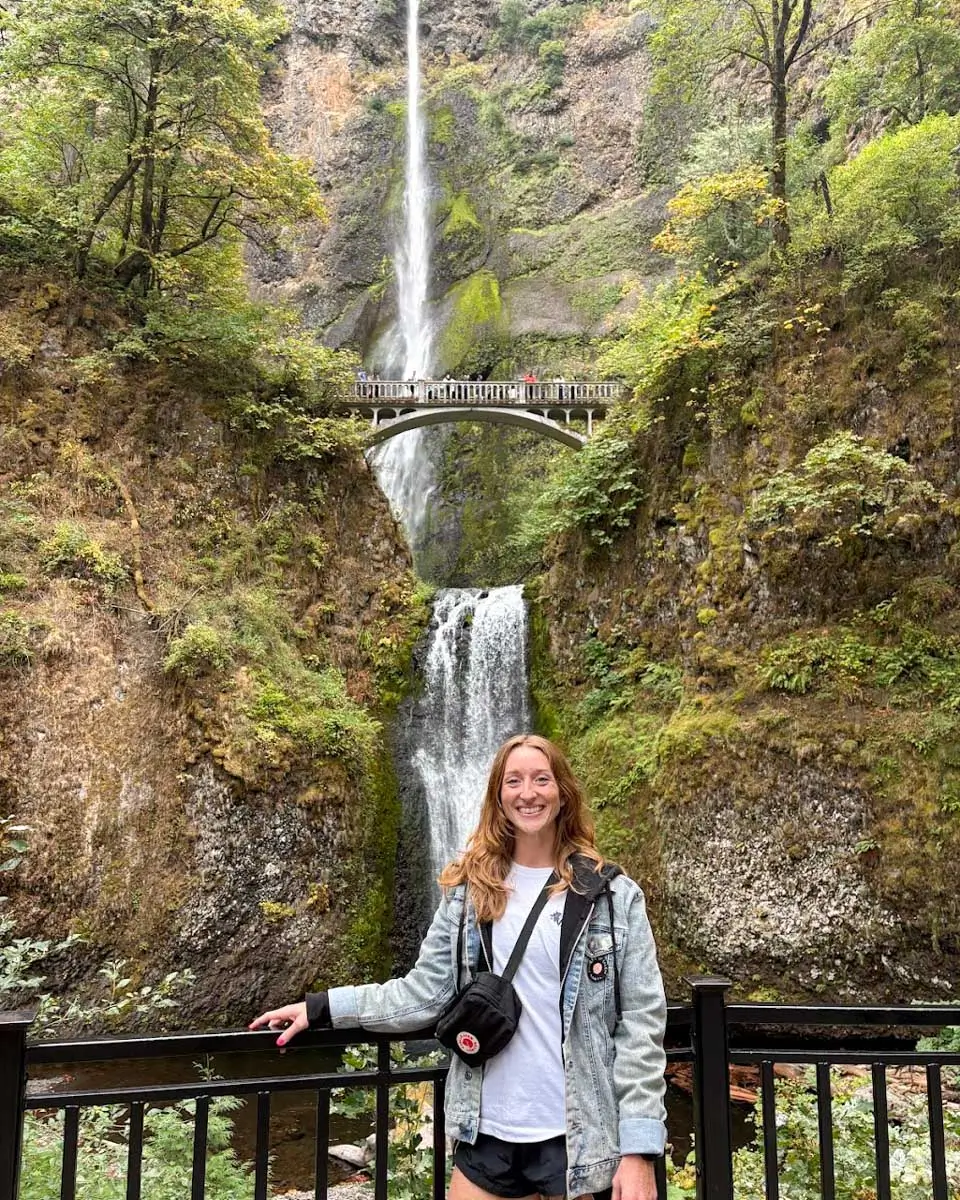 Meghan posing for a photo with Multnomah Falls in background, Portland, Oregon 2