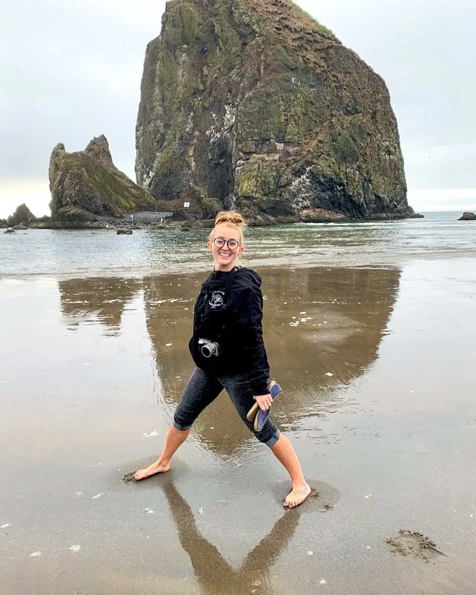 Meghan taking photo at Haystack Rock in Portland, Oregon