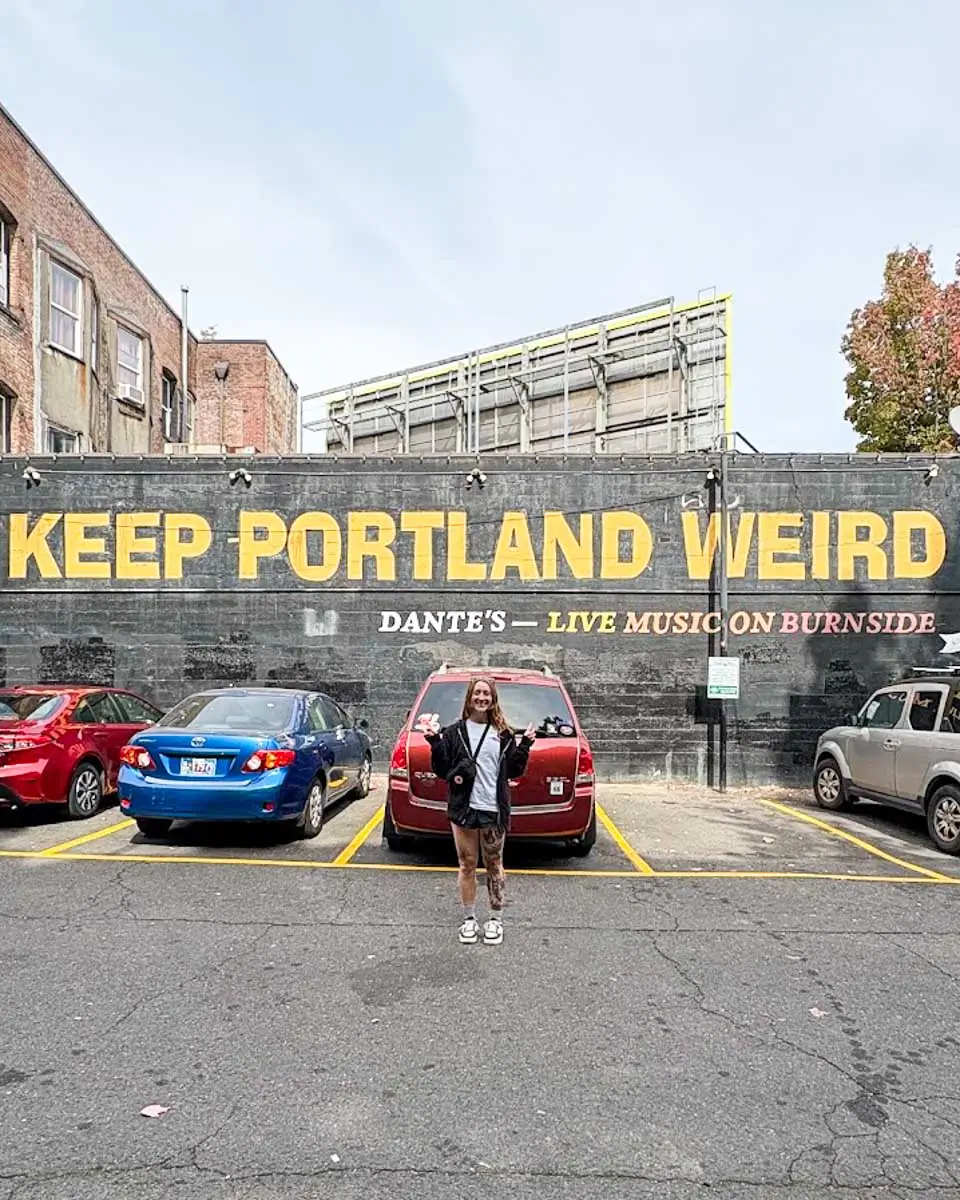 Meghan taking photo in front of Keep Portland Weird sign in Portland, Oregon