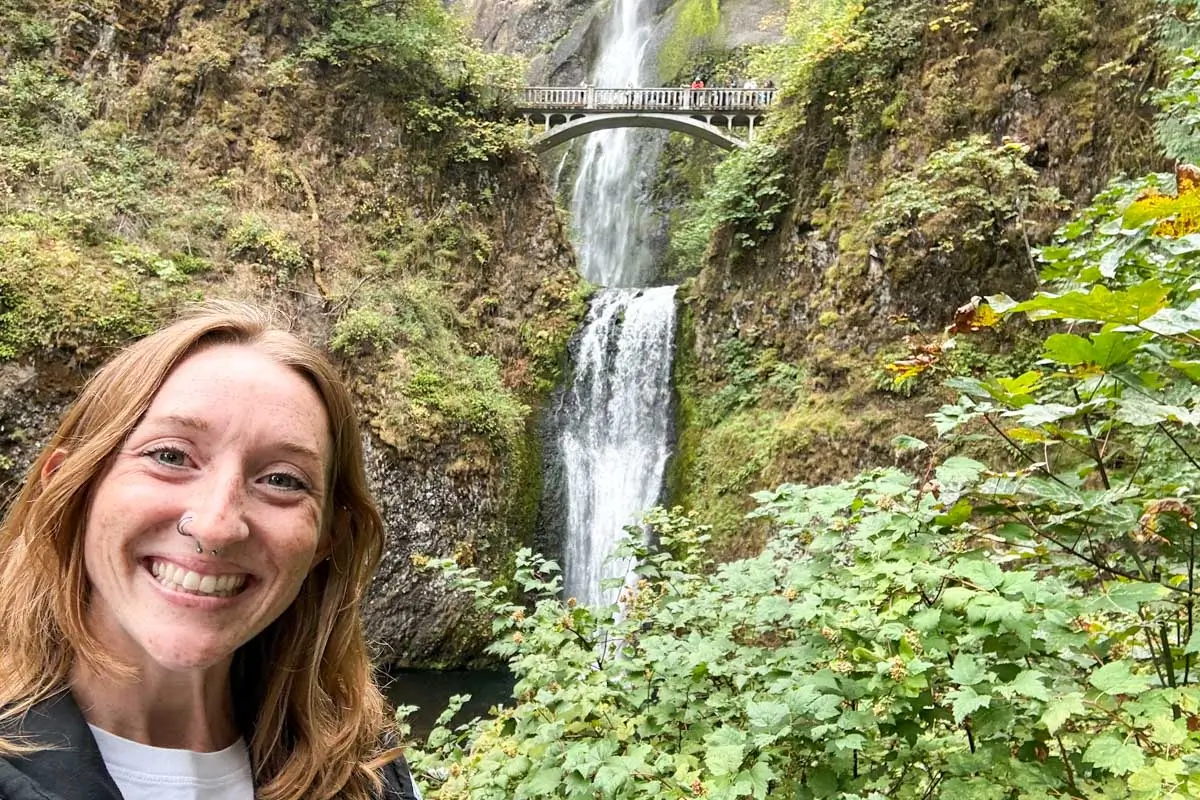 Meghan taking selfie with Multnomah Falls in background, Portland, Oregon