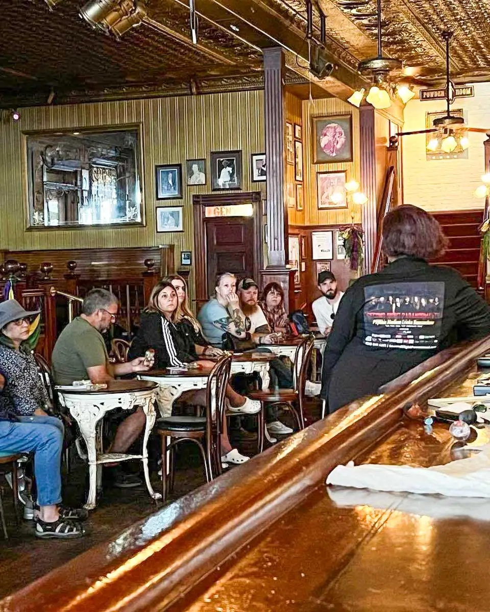 People listening to haunting stories over a meal on a ghost tour in Pensacola, Florida