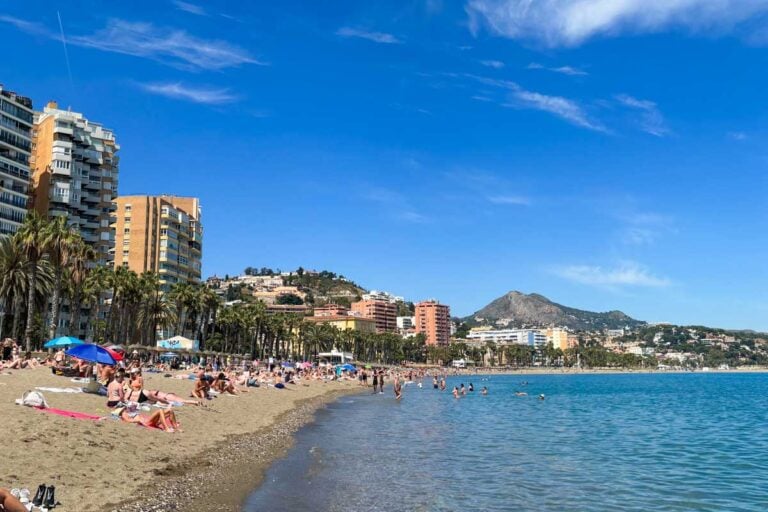 People lounge on Playa La Malagueta in Malaga, spain