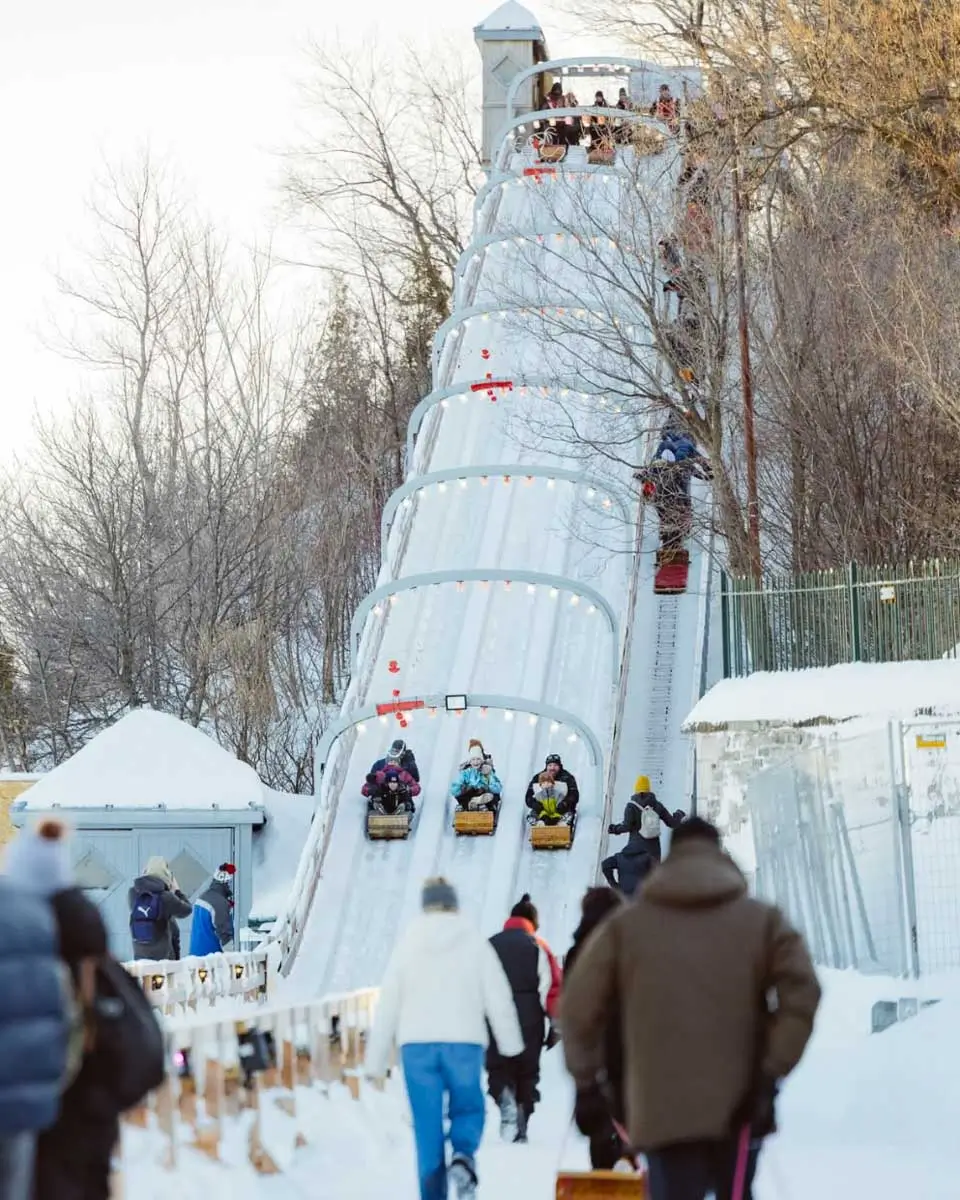 People riding down the toboggan Slide in Old Quebec city, Canada in winter
