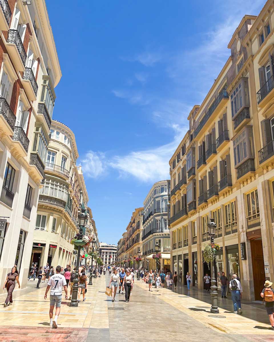 People walk along Calle Larios in Malaga, Spain