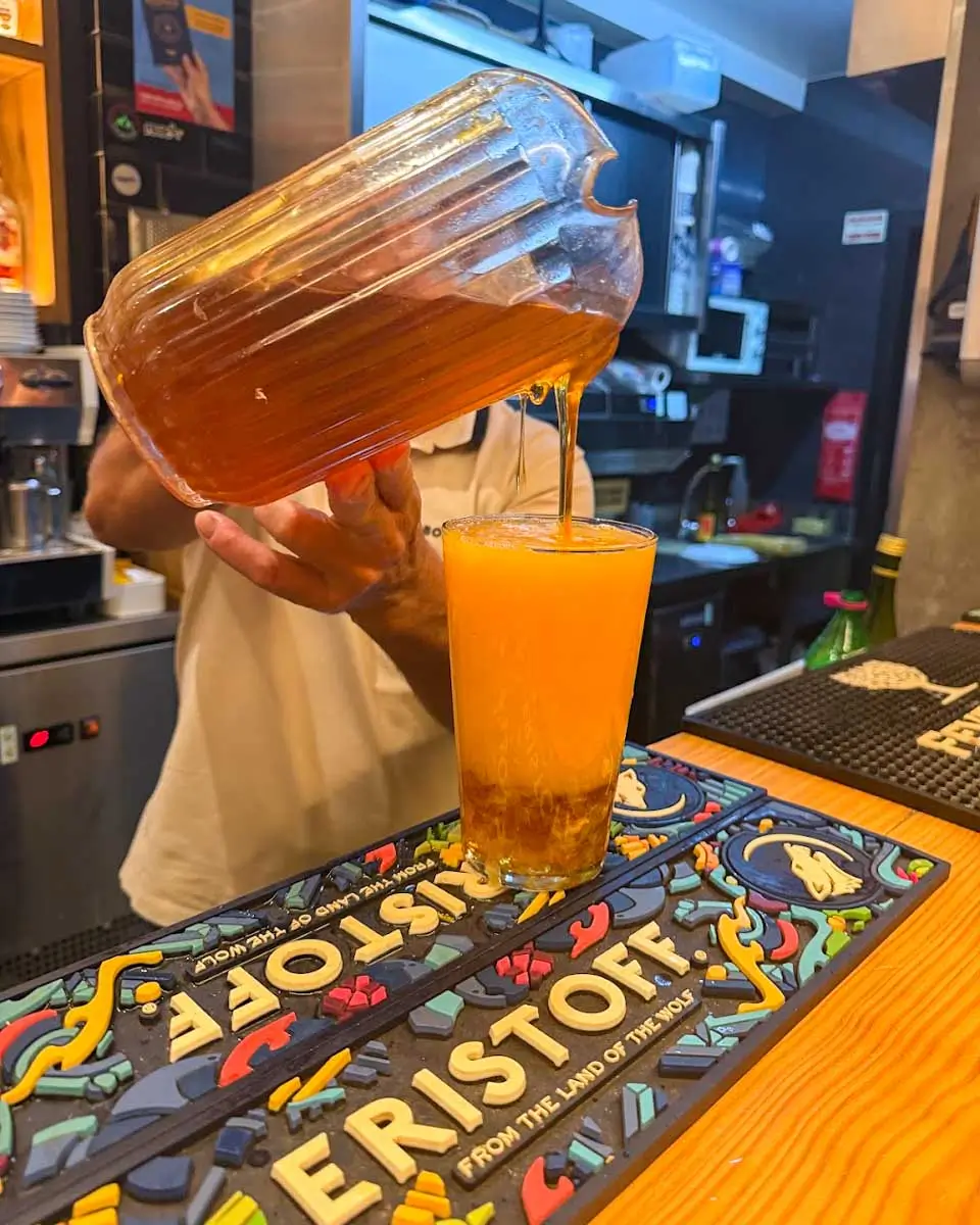 Pouring poncha on a food tour in Madeira, Portugal