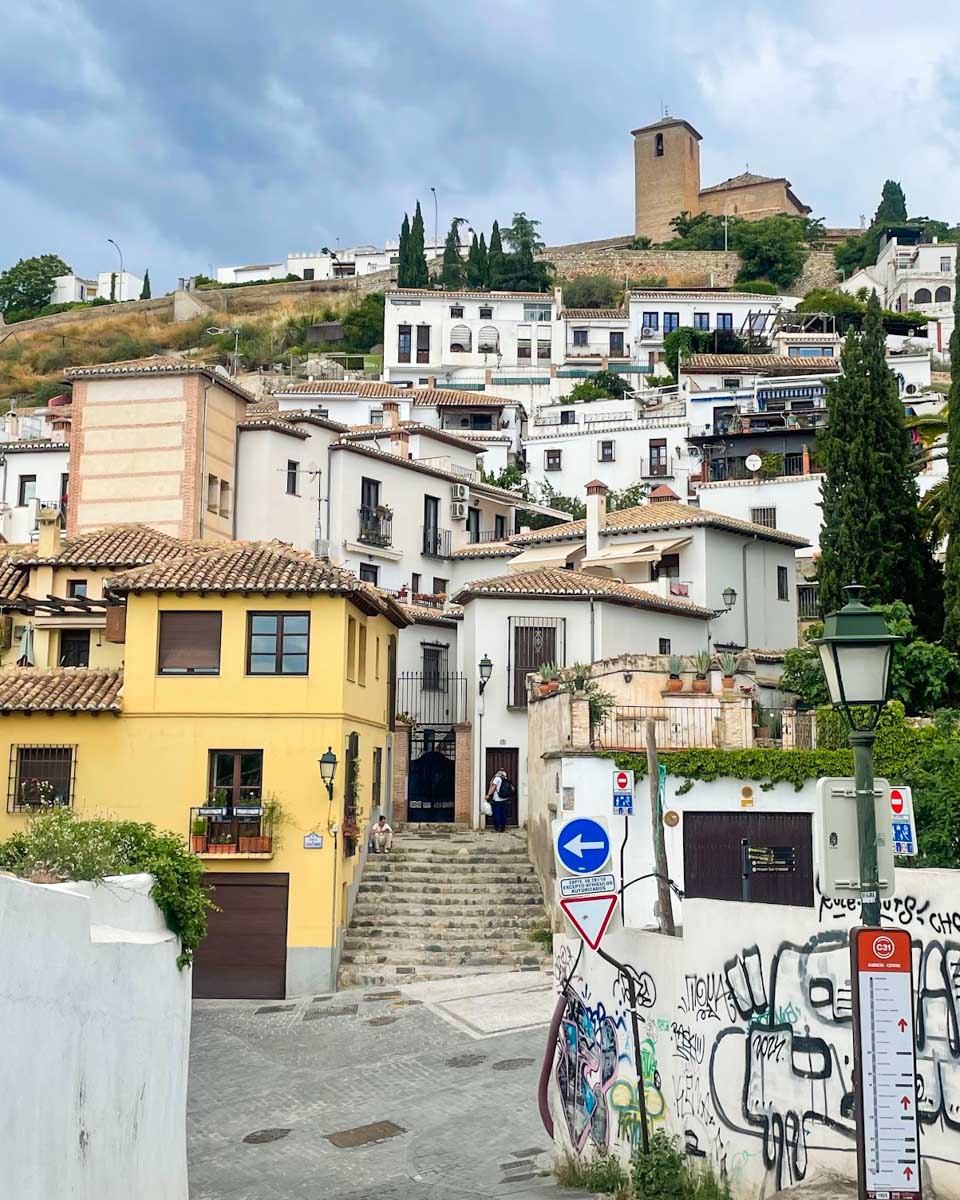 View of houses up a hill in the Albaicín neighborhood of Granada