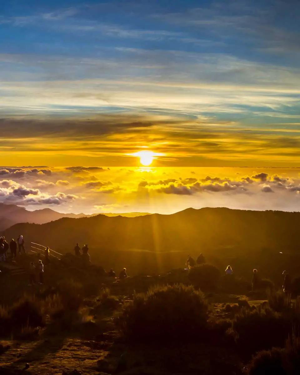 Visitors enjoy a mesmerizing sunset from Pico do Arieiro, Madeira